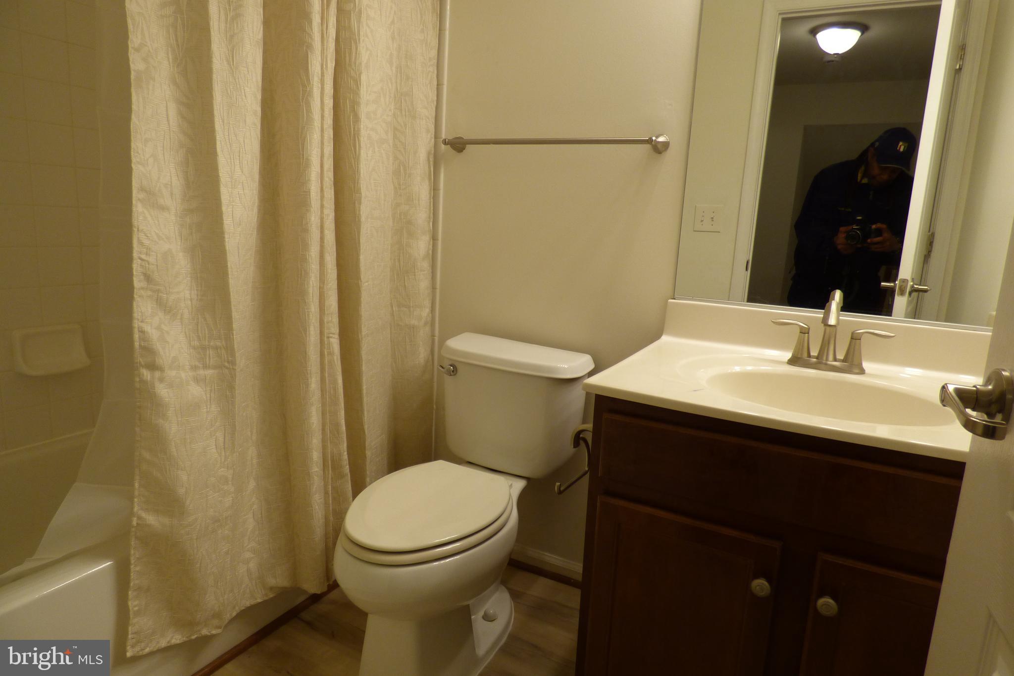 13113 Winding Trail Road Laurel, MD 20707 - Photo 30 of 47 a bathroom with a sink a toilet and shower