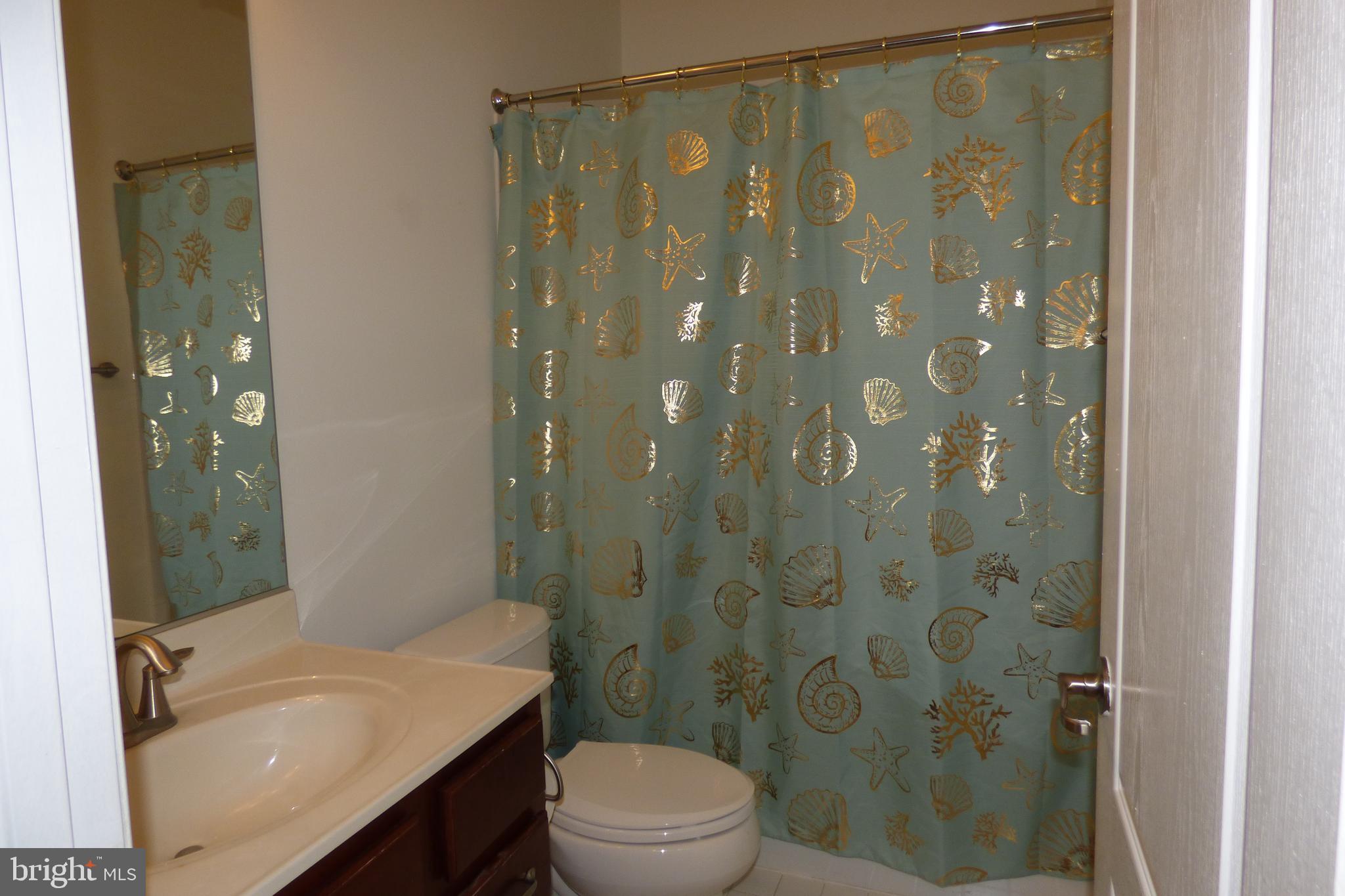 13113 Winding Trail Road Laurel, MD 20707 - Photo 8 of 47 a bathroom with a sink a toilet and shower