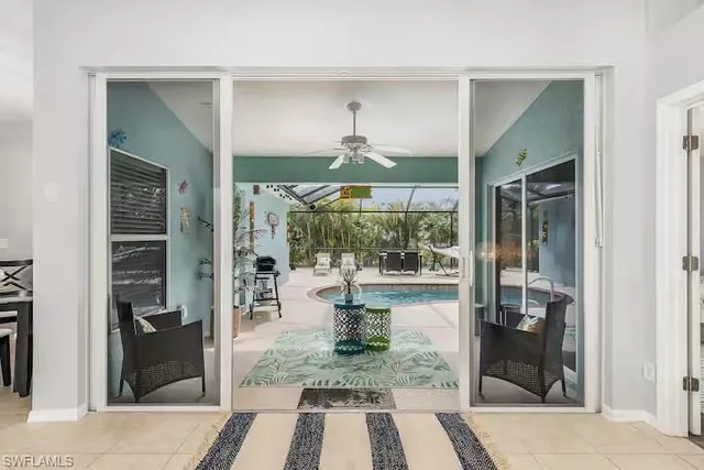 a living room with patio chairs and a table