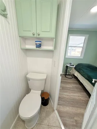 a bathroom with a toilet a sink and a window