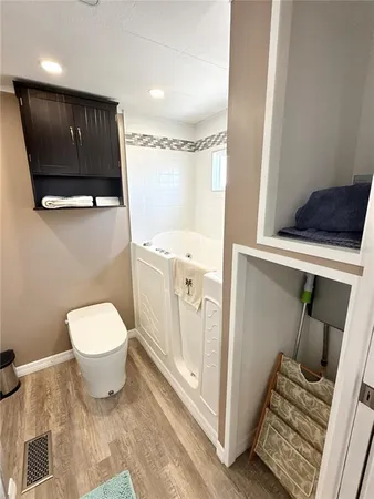 a bathroom with a toilet and a shower