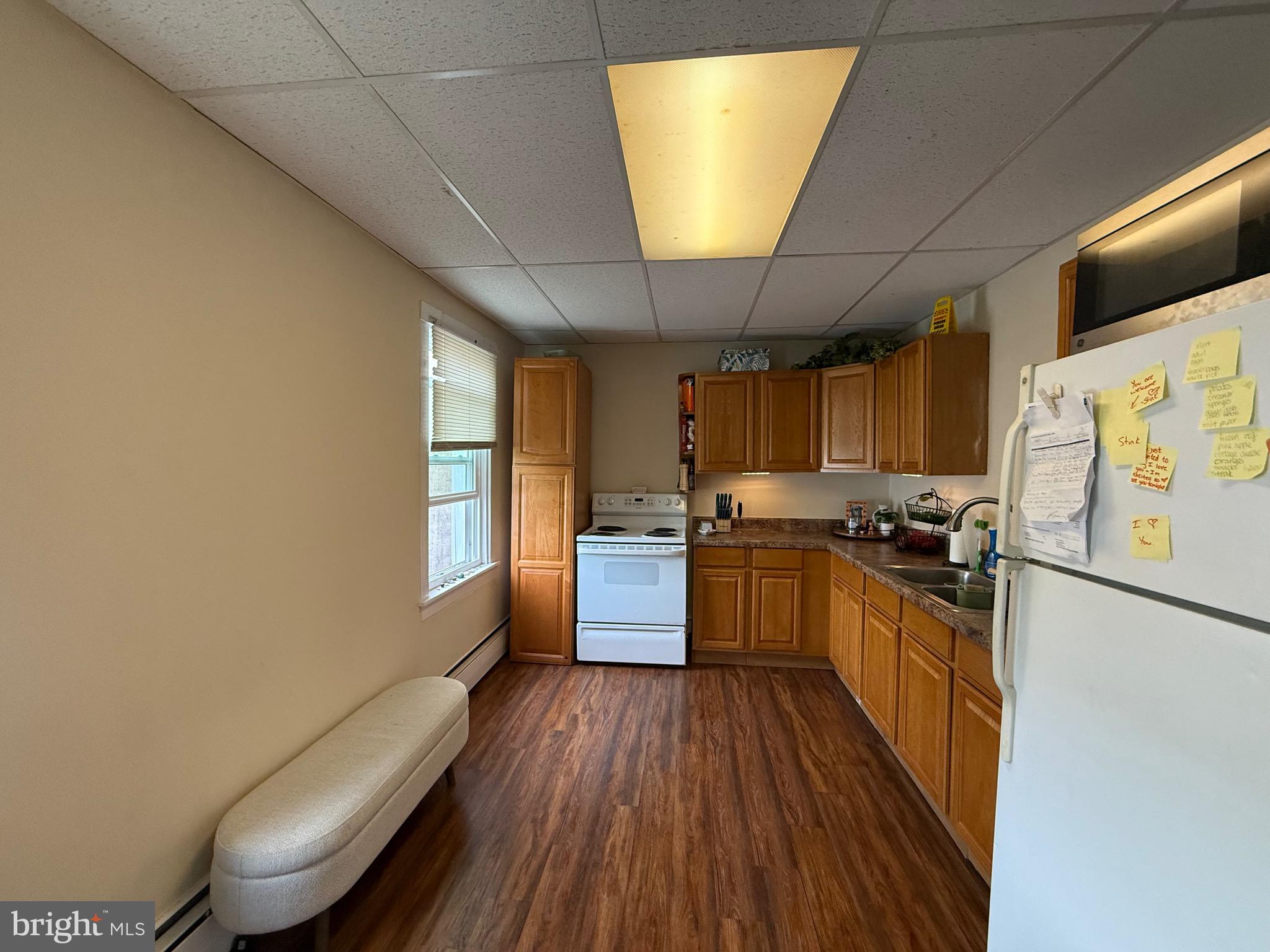 2441 Perkiomen Avenue Reading, PA 19606 - Photo 5 of 13 a kitchen with stainless steel appliances a refrigerator a sink dishwasher a stove and white countertops with wooden floor