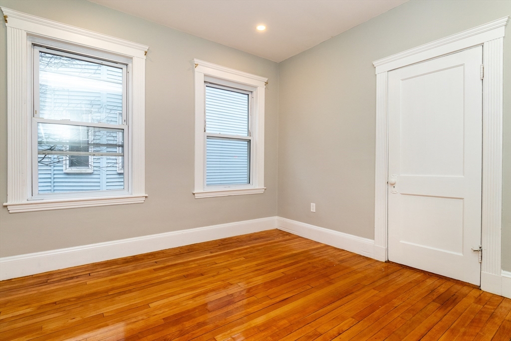 168 Brook Road Milton, MA 02186 - Photo 12 of 25 a view of empty room with wooden floor and fan