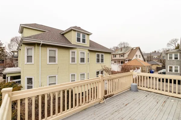 a view of a house with wooden deck