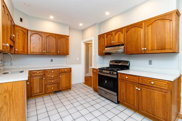 a kitchen with stainless steel appliances granite countertop a stove sink and cabinets