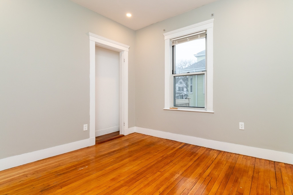 168 Brook Road Milton, MA 02186 - Photo 21 of 25 an empty room with wooden floor and windows