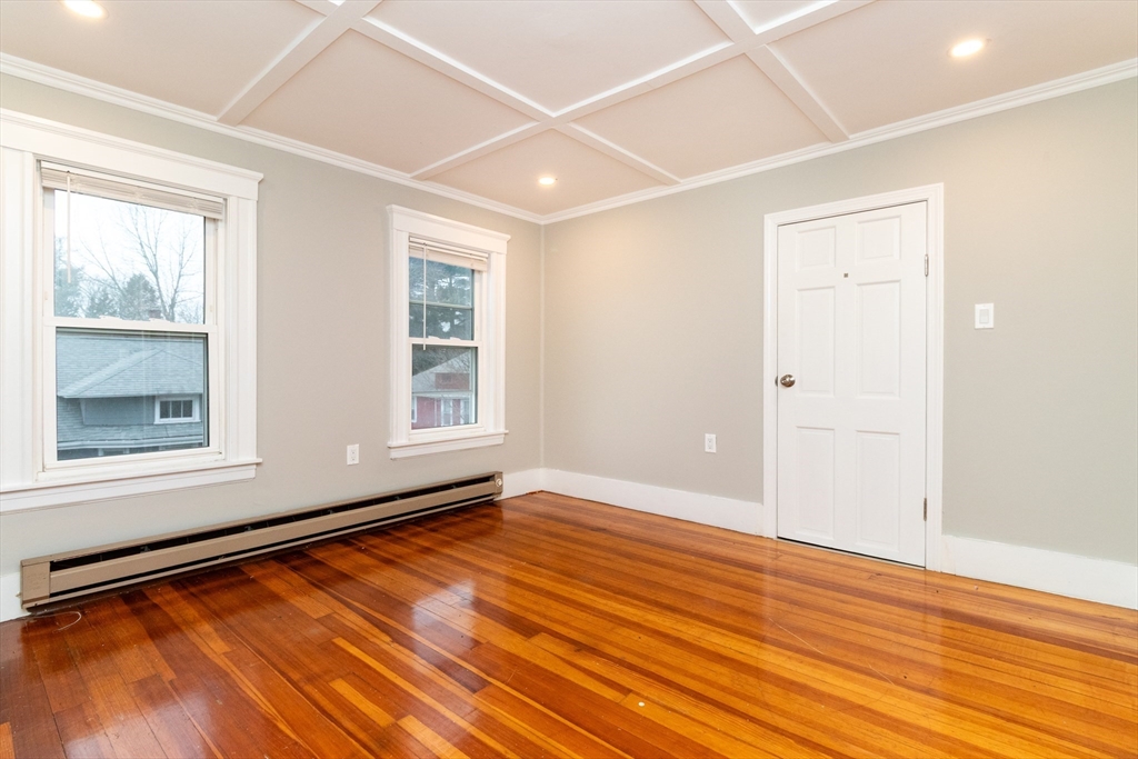 168 Brook Road Milton, MA 02186 - Photo 24 of 25 a view of an empty room with wooden floor and a window
