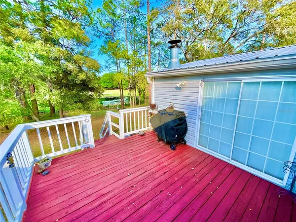 a view of balcony with wooden floor and fence