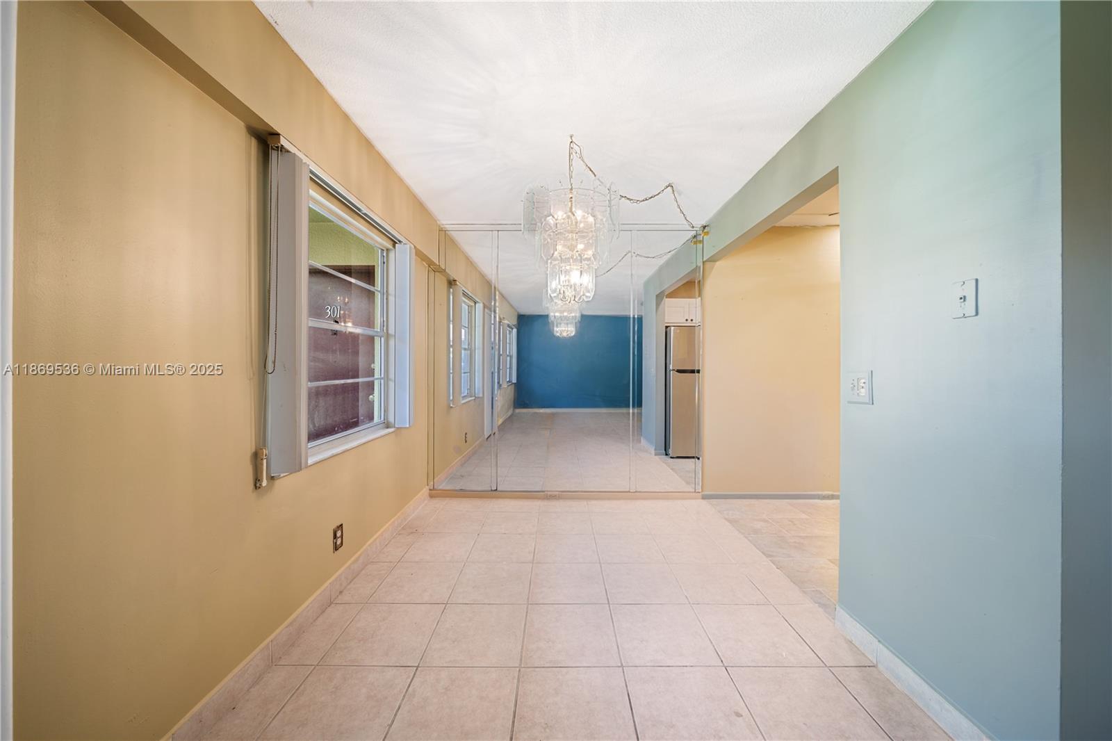 13455 Southwest 3rd Street, Unit 302S Pembroke Pines, FL 33027 - Photo 18 of 24 a view of a hallway with a chandelier