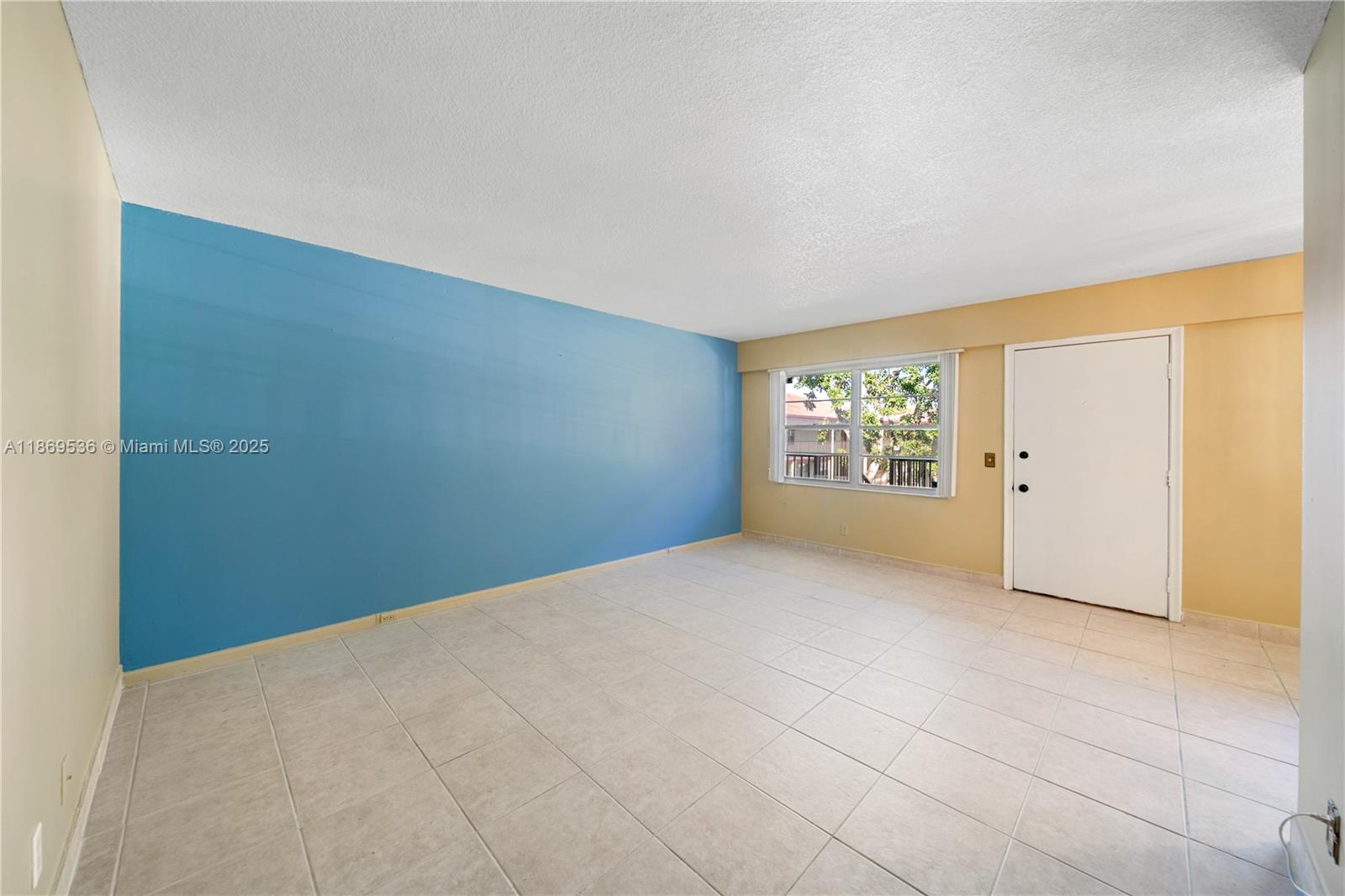 13455 Southwest 3rd Street, Unit 302S Pembroke Pines, FL 33027 - Photo 2 of 24 a view of an empty room with a window
