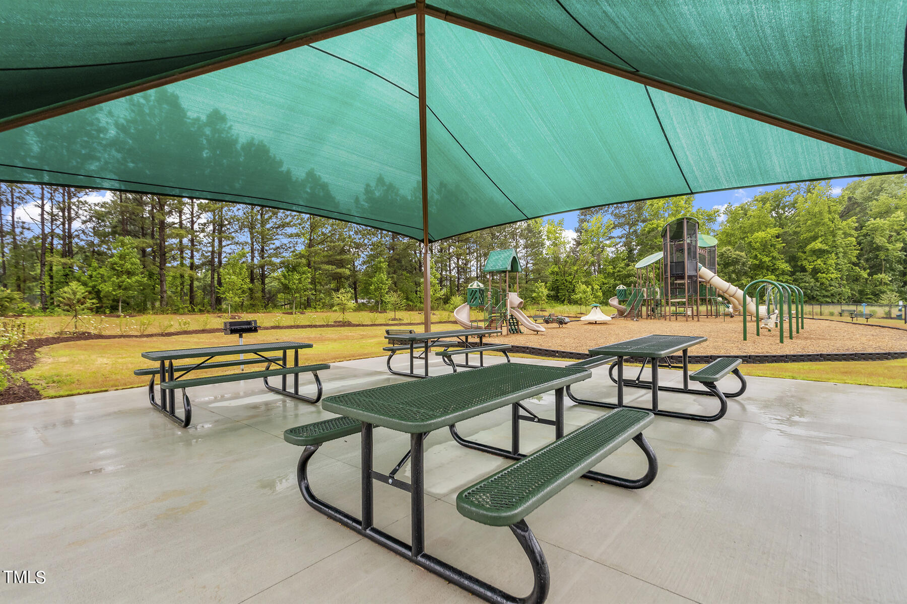 358 Coleshill Road Angier, NC 27501 - Photo 13 of 14 an outdoor sitting area with chairs and umbrella