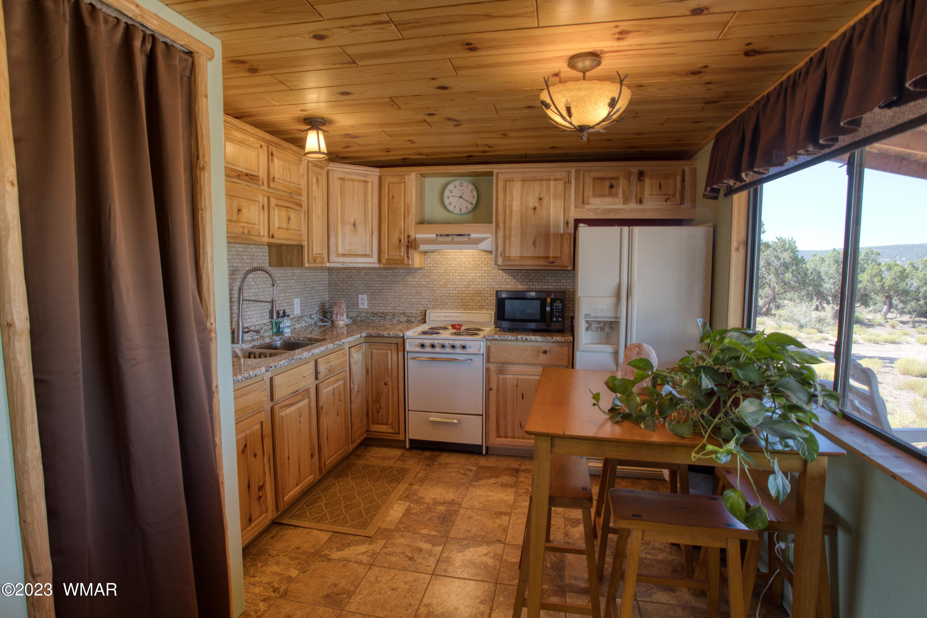 4558 Stirrup Road Snowflake, AZ 85937 - Photo 4 of 16 a kitchen with refrigerator and window