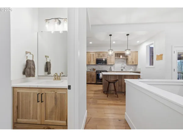a kitchen with kitchen island a sink counter top space and appliances