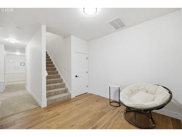 a view of a room with wooden floor and lounge chair