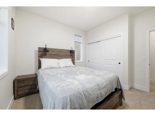 a bathroom with a granite countertop toilet sink and mirror