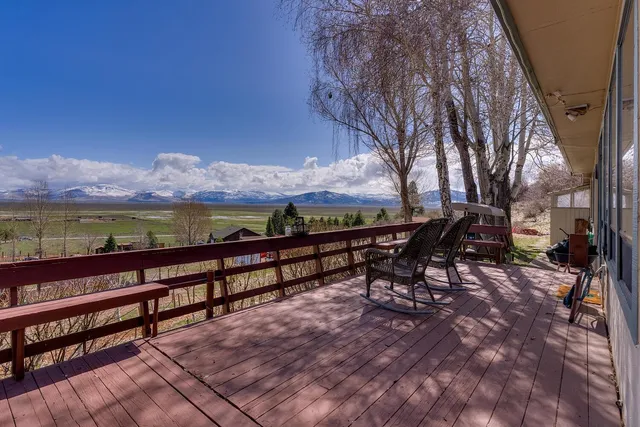 a view of a roof deck with table and chairs