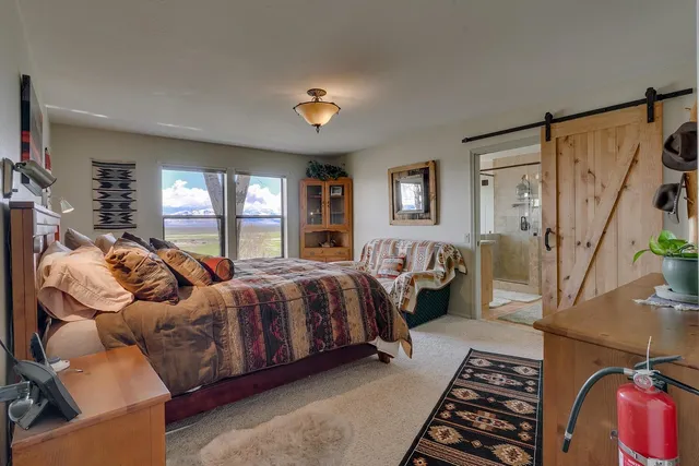 a spacious bedroom with a bed and a couch