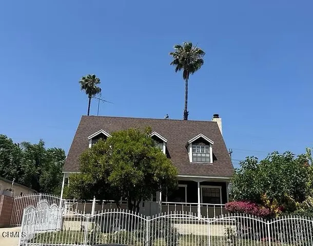 a kitchen with a sink a counter space and wooden cabinets
