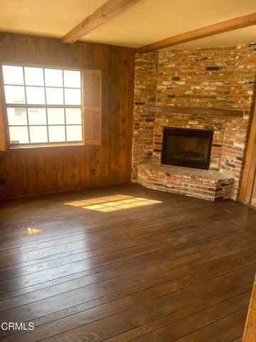 a view of hallway with wooden floor