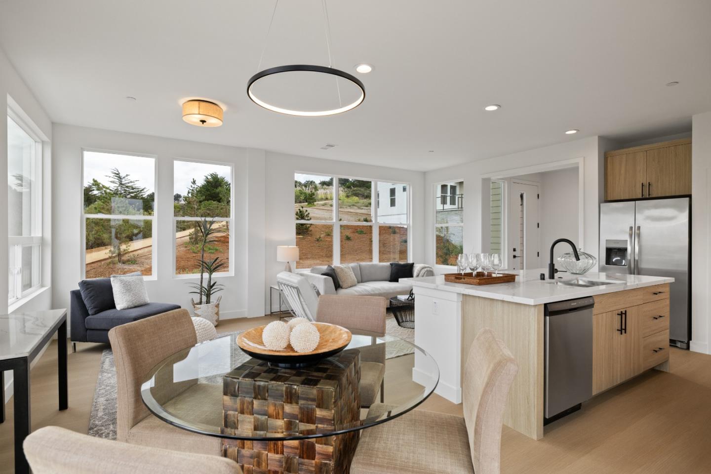 823 Fassler, Unit 823 Pacifica, CA 94044 - Photo 7 of 37 a dining room with furniture a large window and a chandelier