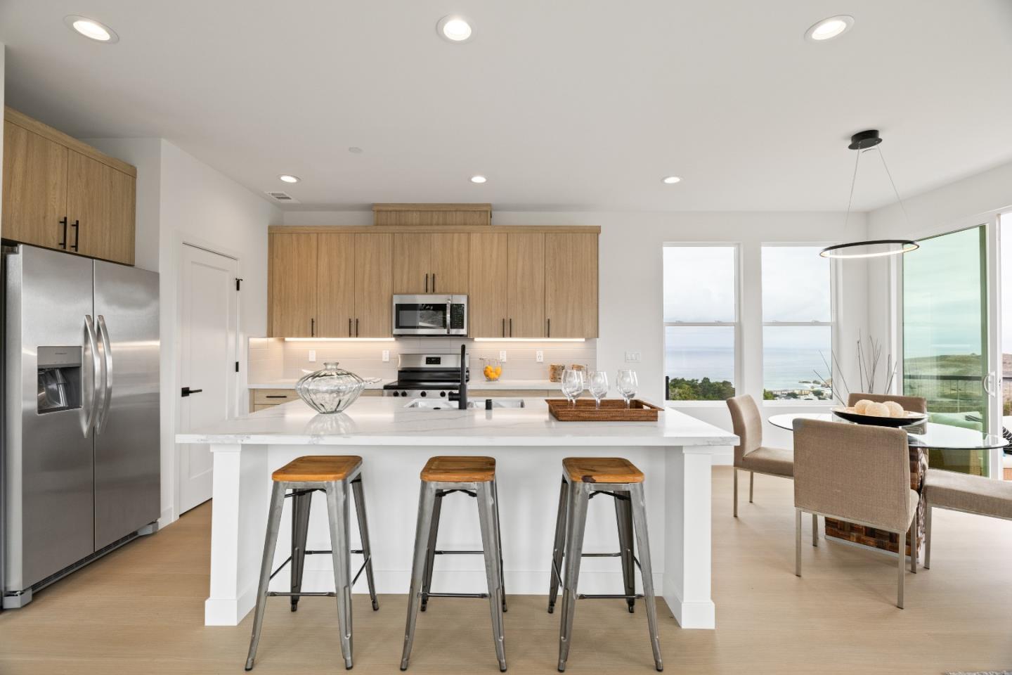 823 Fassler, Unit 823 Pacifica, CA 94044 - Photo 9 of 37 a kitchen with stainless steel appliances granite countertop white cabinets a table and chairs