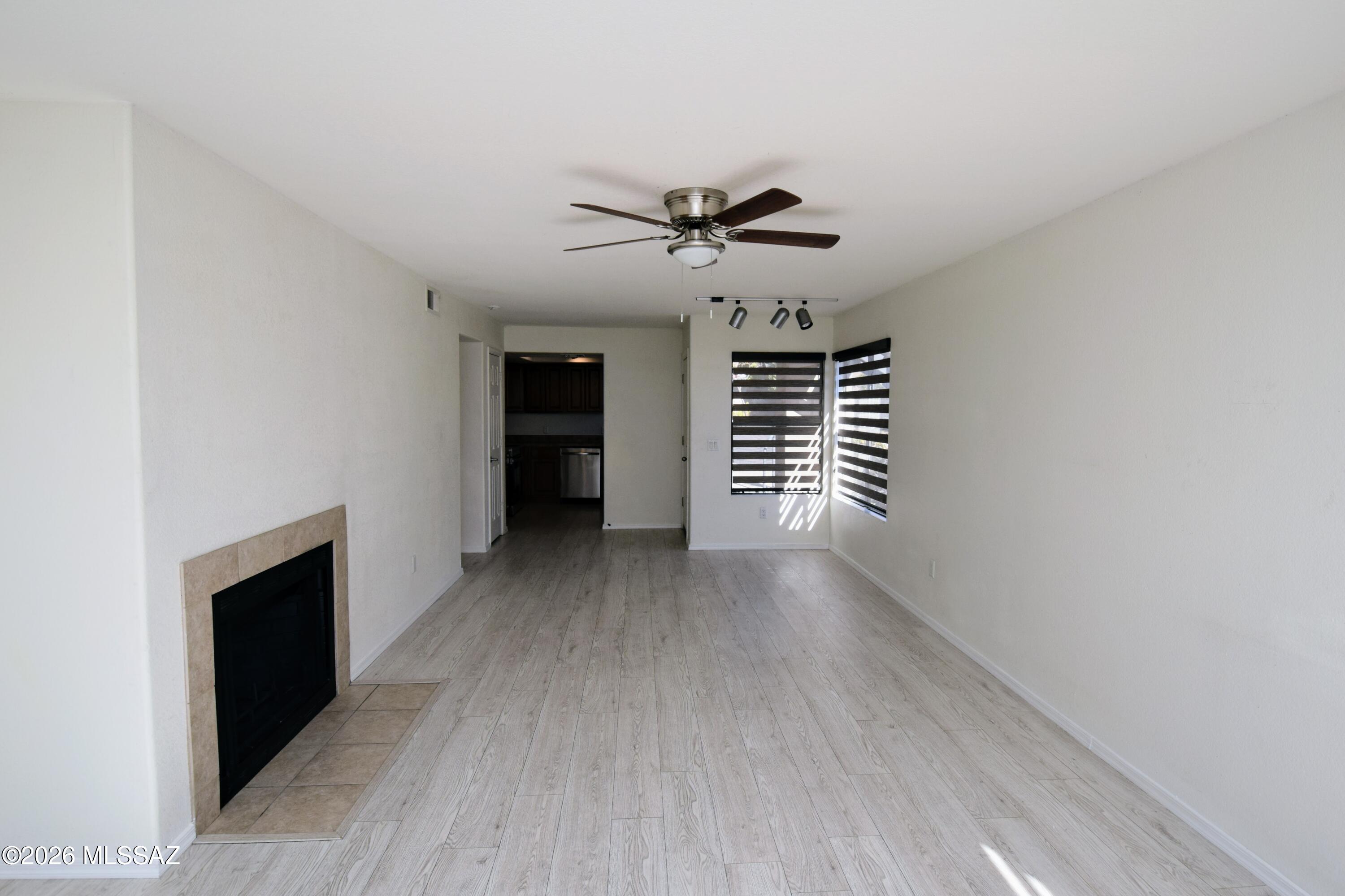 5855 North Kolb Road, Unit 11106 Tucson, AZ 85750 - Photo 7 of 36 wooden floor in an empty room with a fireplace