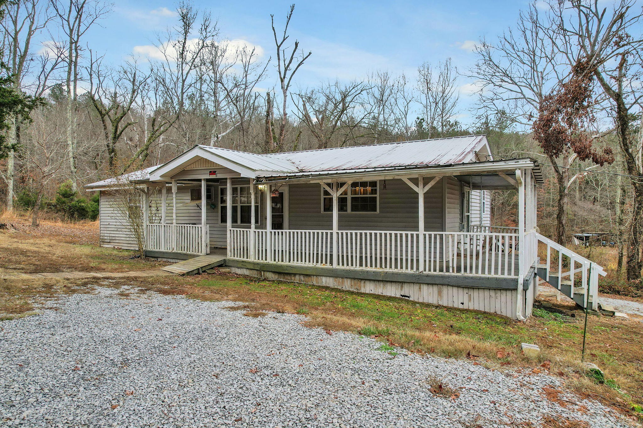 a view of a house with a yard and wooden fence