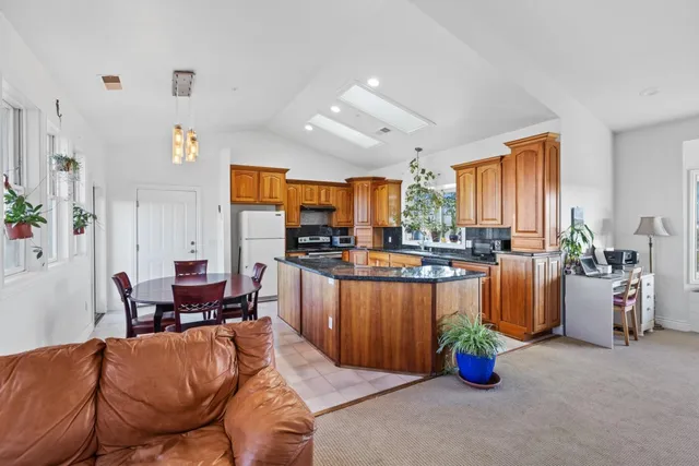 a living room with furniture and kitchen view