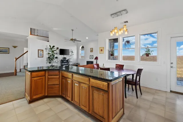 a kitchen with stainless steel appliances granite countertop a sink and a refrigerator