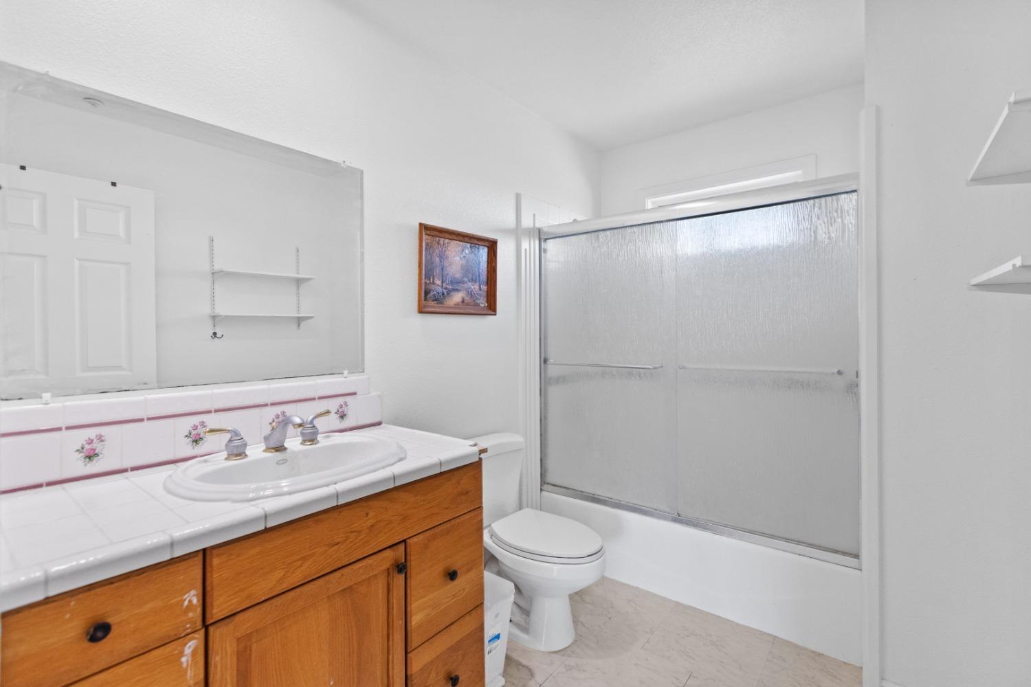 44643 County Road 29 Davis, CA 95618 - Photo 26 of 36 a bathroom with a granite countertop sink toilet and shower