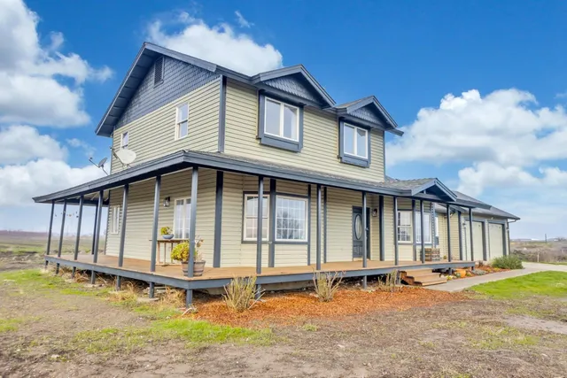 a front view of a house with a garden and deck
