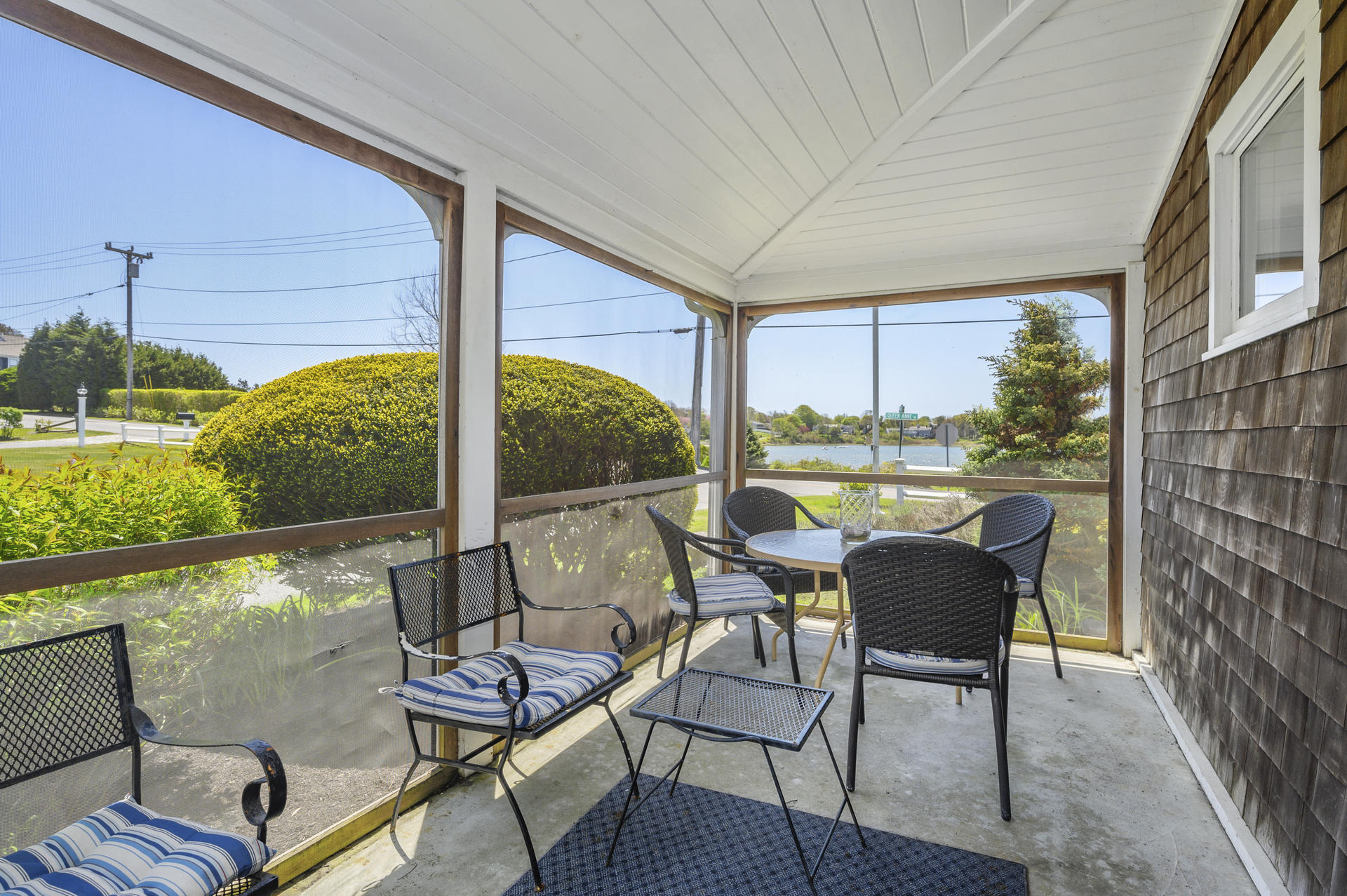133 Queen Anne Road Chatham, MA 02633 - Photo 13 of 52 a balcony with furniture and a floor to ceiling window