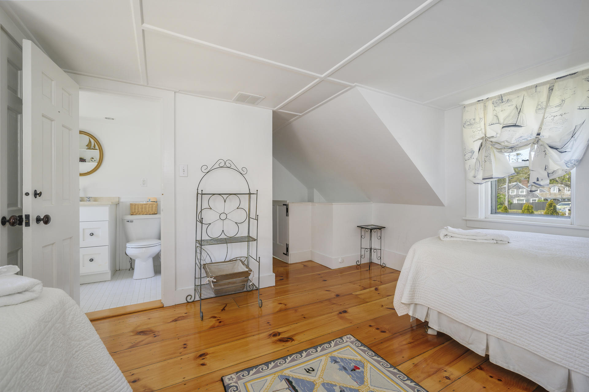 133 Queen Anne Road Chatham, MA 02633 - Photo 26 of 52 a bedroom with a bed a dresser and a large window