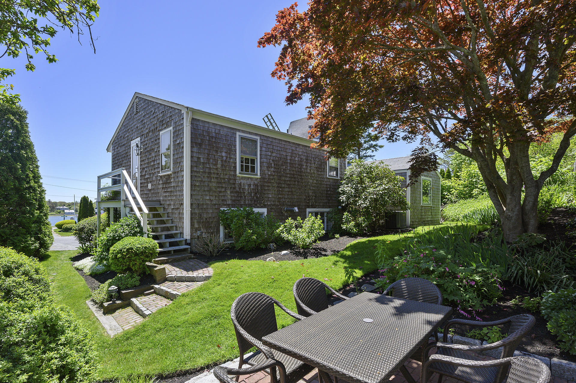 133 Queen Anne Road Chatham, MA 02633 - Photo 35 of 52 a view of a chair and table in backyard of the house