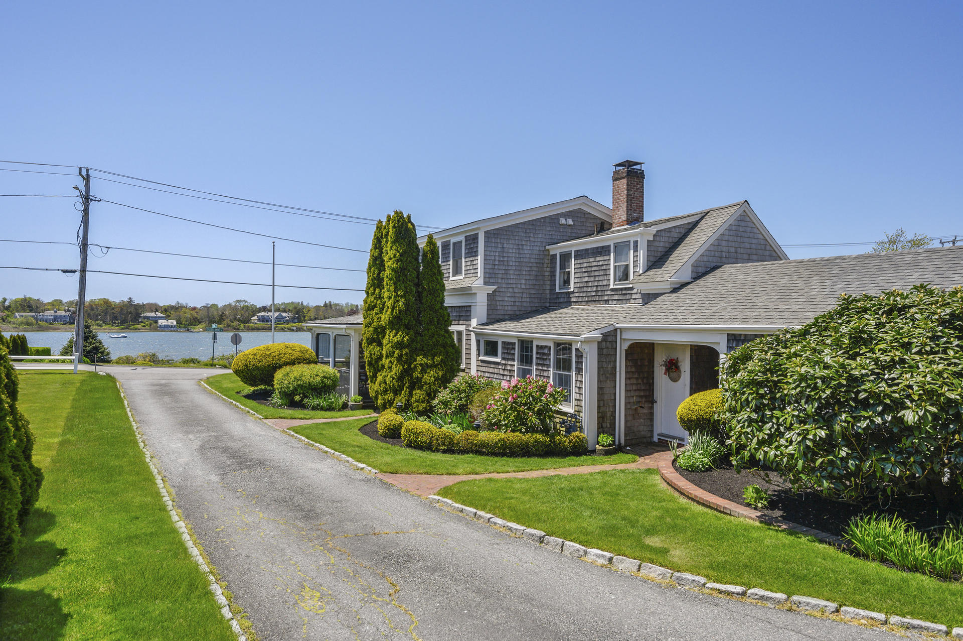 133 Queen Anne Road Chatham, MA 02633 - Photo 4 of 52 a front view of a house with a yard