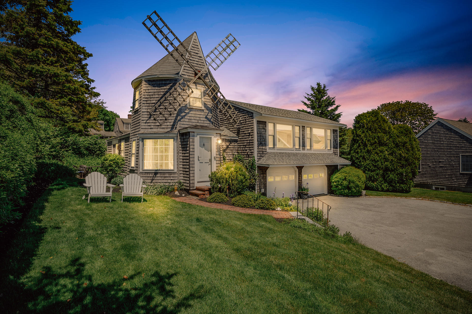 133 Queen Anne Road Chatham, MA 02633 - Photo 41 of 52 a front view of a house with a yard fire pit and outdoor seating