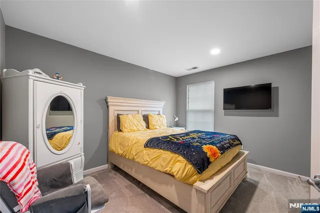 a bedroom with a bed and a television