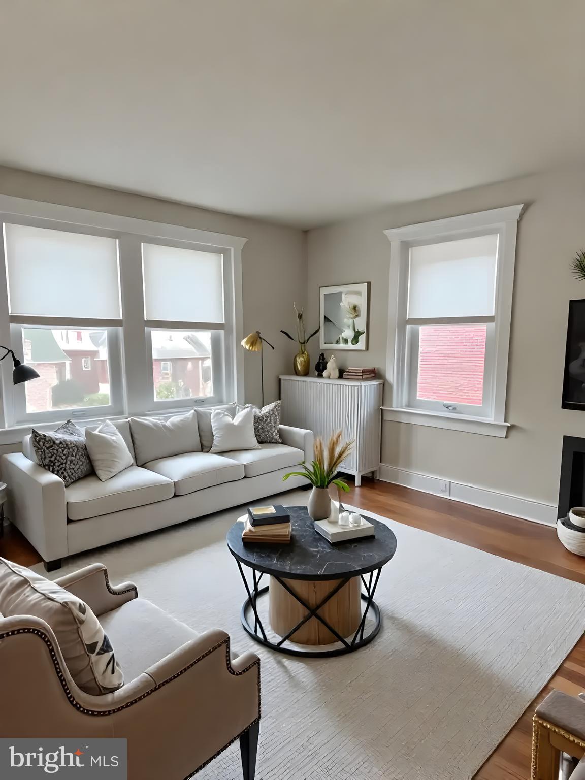 112 North Miller Street, Unit 2 Reading, PA 19607 - Photo 9 of 24 a living room with furniture a wooden floor and a large window