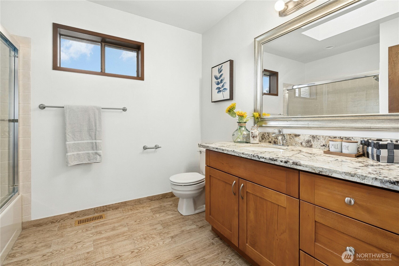 5211 103rd Street Southwest, Unit SW Mukilteo, WA 98275 - Photo 27 of 40 a bathroom with a granite countertop toilet sink and mirror