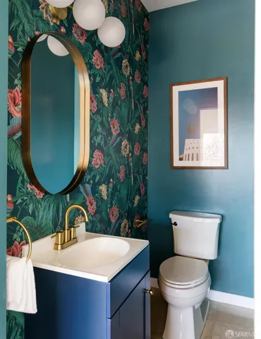 a bathroom with a toilet sink and mirror