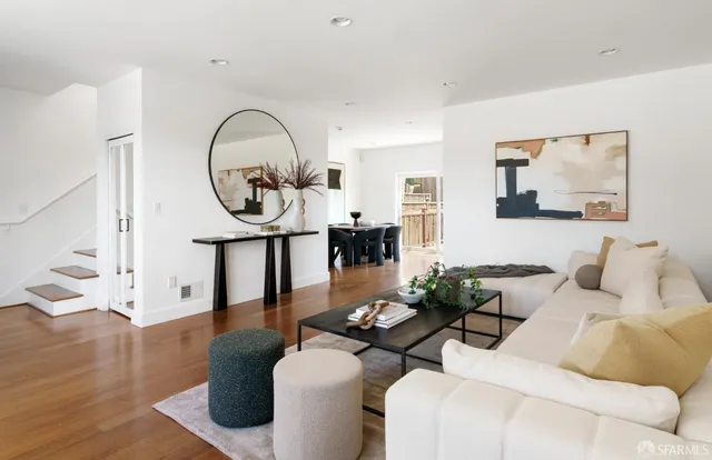 a living room with furniture a table and wooden floor