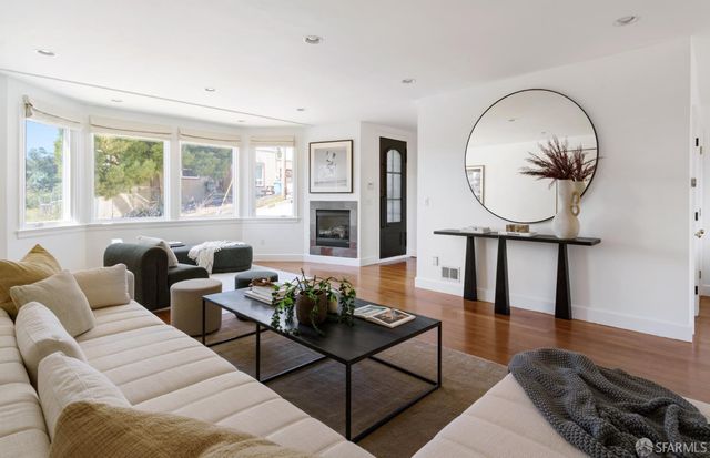 a living room with furniture a rug and a window