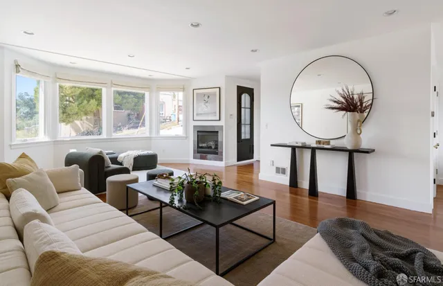 a living room with furniture a rug and a window