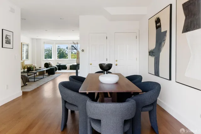 a view of a dining room with furniture and wooden floor