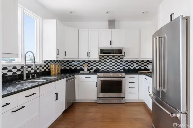 a kitchen with stainless steel appliances a stove and a refrigerator