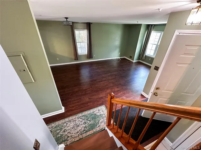 a view of entryway with stairs and wooden floor