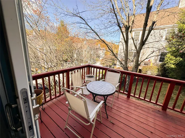 a balcony with furniture and wooden floor