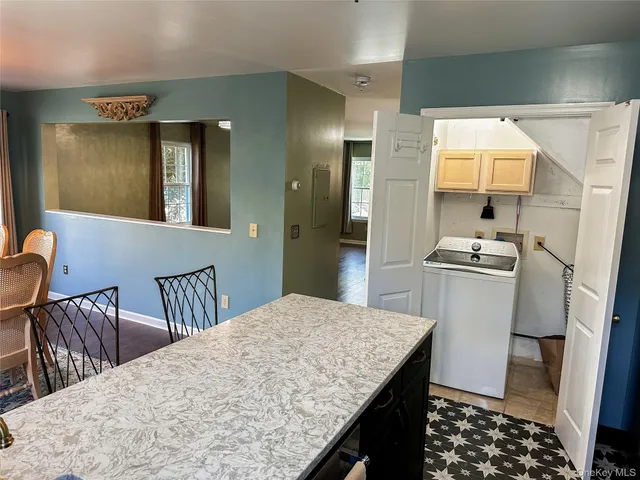 a kitchen with a table chairs sink and refrigerator