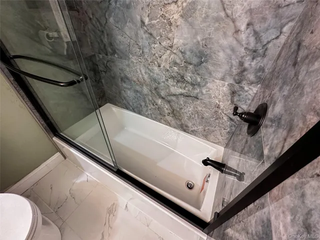 a front view of a house with balcony and trees