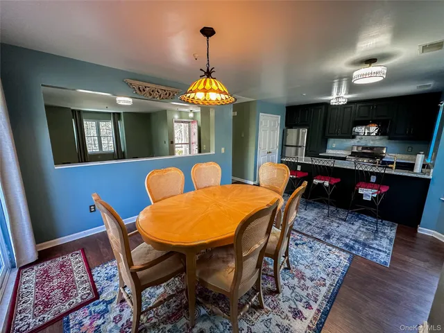 a dining room with furniture and chandelier